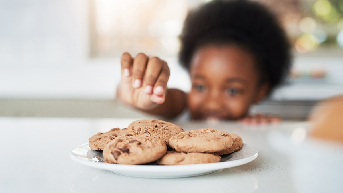 a little girl who steals cookies from home