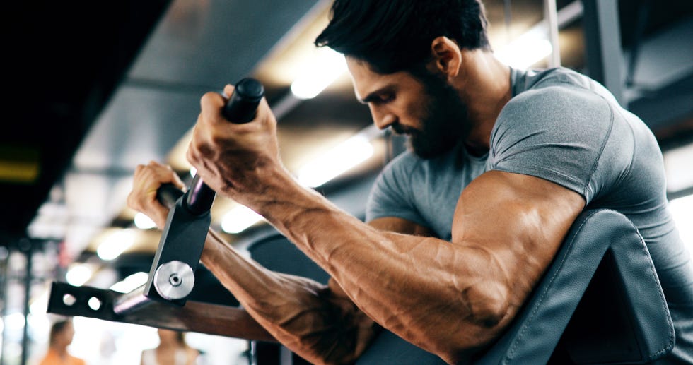 a handsome guy doing exercises at the gym