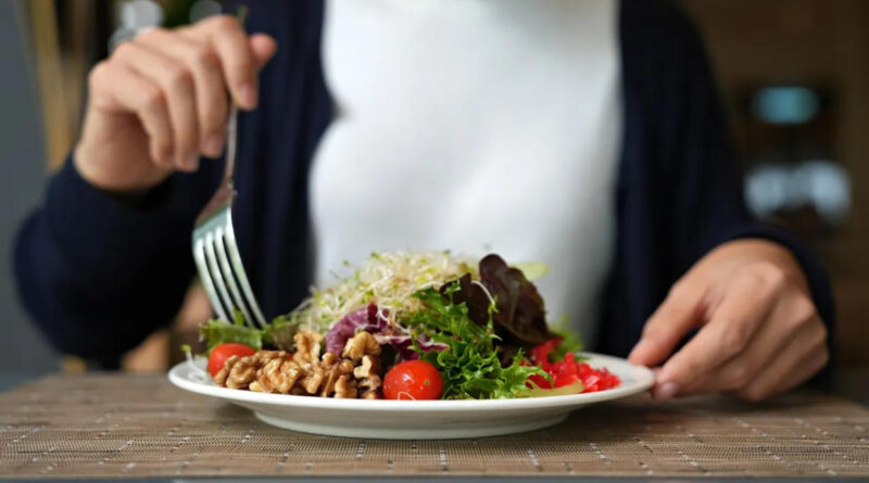 A woman eating a salad