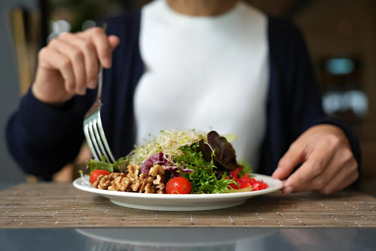 A woman eating a salad